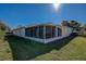 Enjoy the outdoors from this home's expansive screened-in porch overlooking the lush backyard and green space at 29417 Caddyshack Ln, San Antonio, FL 33576