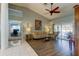 Living room with hardwood floors, vaulted ceiling and sliding doors to patio at 310 Washington Ave, Oldsmar, FL 34677