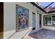 Outdoor patio with ornate tile wall and seating area at 310 Washington Ave, Oldsmar, FL 34677