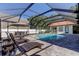 Inviting pool area with lounge chairs under a covered patio at 310 Washington Ave, Oldsmar, FL 34677