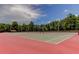 Well-maintained tennis courts with red and green surfaces at 3382 Mermoor Dr # 3201, Palm Harbor, FL 34685