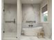 Spa-like bathroom with soaking tub, walk-in shower, and marble finishes at 3819 71St N St, St Petersburg, FL 33709