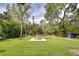 Expansive backyard with a fire pit and outdoor dining area, perfect for entertaining guests at 4643 John Moore Rd, Brandon, FL 33511
