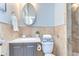 Bathroom featuring a quartz vanity, decorative mirror, tile backsplash, and updated fixtures at 4643 John Moore Rd, Brandon, FL 33511