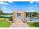 Brick-paved pool deck with pergola and lake access at 4750 Dolphin Cay S Ln # 308, St Petersburg, FL 33711