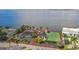 Aerial view of two houses, tennis court, and waterfront access at 5029 W San Miguel St, Tampa, FL 33629