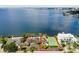 Aerial view of waterfront property with pool and tennis court at 5029 W San Miguel St, Tampa, FL 33629