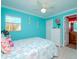 Charming bedroom with light blue walls, and coastal bedding at 5605 Shore S Blvd # B, Gulfport, FL 33707