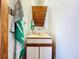 Simple bathroom with a vanity, mirror, and wood-paneled ceiling at 5661 Tower Rd, Land O Lakes, FL 34638