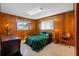 Bedroom with wood-paneled walls and green bedding at 6348 29Th N Ave, St Petersburg, FL 33710