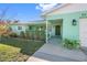 Inviting front yard with lush landscaping, a walkway, and covered entryway at 6348 29Th N Ave, St Petersburg, FL 33710