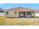 Tan house exterior with screened porch and grassy backyard at 7343 Forest Mere Dr, Riverview, FL 33578