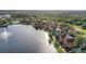 Aerial view showing community pool and lakefront townhouses at 9320 Lake Chase Island Way, Tampa, FL 33626