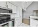 Kitchen features stainless steel appliances and grey cabinets at 9320 Lake Chase Island Way, Tampa, FL 33626