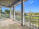 Spacious balcony with white railings and a view of a grassy area at 10130 Balcony St, New Port Richey, FL 34655