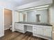 Bathroom with double vanity, large mirror, and soaking tub at 10130 Balcony St, New Port Richey, FL 34655