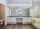 Elegant bathroom boasts double vanity, a large mirror, and soaking tub at 10130 Balcony St, New Port Richey, FL 34655