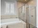 Bathroom features a soaking tub and a shower stall at 10130 Balcony St, New Port Richey, FL 34655