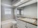 Bathroom with granite vanity and tiled shower/tub at 10130 Balcony St, New Port Richey, FL 34655