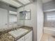 Guest bathroom with granite countertop and tiled floors at 10130 Balcony St, New Port Richey, FL 34655