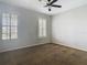 Bright bedroom with carpet, ceiling fan, and large windows at 10130 Balcony St, New Port Richey, FL 34655