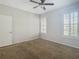 Charming bedroom with carpet, ceiling fan, and door access at 10130 Balcony St, New Port Richey, FL 34655