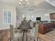 Open concept dining area with glass table and kitchen view at 10130 Balcony St, New Port Richey, FL 34655