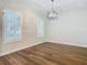 Dining room with hardwood floors and large windows at 10130 Balcony St, New Port Richey, FL 34655