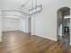 Open dining area with hardwood floors and arched entryways at 10130 Balcony St, New Port Richey, FL 34655