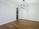 Dining room with hardwood floors and view into kitchen at 10130 Balcony St, New Port Richey, FL 34655