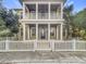 Two-story house with a front porch and white picket fence at 10130 Balcony St, New Port Richey, FL 34655