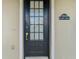 Black front door with glass panes and gold handle at 10130 Balcony St, New Port Richey, FL 34655