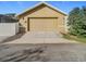 Attached garage with tan exterior and driveway at 10130 Balcony St, New Port Richey, FL 34655