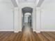 Bright hallway with hardwood floors and arched doorways at 10130 Balcony St, New Port Richey, FL 34655