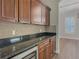 Kitchen boasts dark wood cabinets, granite counters, and wine fridge at 10130 Balcony St, New Port Richey, FL 34655