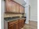 Well-appointed kitchen with dark wood cabinets and granite counters at 10130 Balcony St, New Port Richey, FL 34655
