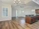 Open concept kitchen with island, granite countertops and dark wood cabinets at 10130 Balcony St, New Port Richey, FL 34655