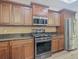 Modern kitchen with stainless steel appliances and dark wood cabinets at 10130 Balcony St, New Port Richey, FL 34655