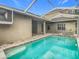Inviting pool and spa with screened enclosure at 10130 Balcony St, New Port Richey, FL 34655