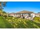 House with a large backyard, grassy area, and privacy fence at 10431 Machrihanish Cir, San Antonio, FL 33576