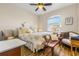 Charming bedroom with floral bedding and sitting area at 10431 Machrihanish Cir, San Antonio, FL 33576