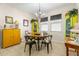 Bright dining area with a round wooden table and four black chairs at 10431 Machrihanish Cir, San Antonio, FL 33576
