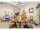 A well-lit dining area with a copper table and four black chairs at 10431 Machrihanish Cir, San Antonio, FL 33576