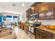 Eat-in kitchen with granite countertops and stainless steel appliances at 10431 Machrihanish Cir, San Antonio, FL 33576