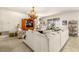 Spacious living room with large sectional sofa and elegant chandelier at 10431 Machrihanish Cir, San Antonio, FL 33576