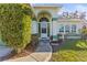 Front entrance with walkway and lush green shrubs at 10836 Midland Bridge Rd, Hudson, FL 34667