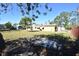 View of the house from the backyard, showing a large grassy area at 1360 Prescott S St, St Petersburg, FL 33712