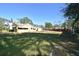 Spacious backyard with a grassy area and mature trees at 1360 Prescott S St, St Petersburg, FL 33712