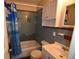 Clean bathroom with blue tile, shower/tub combo, and vanity at 1360 Prescott S St, St Petersburg, FL 33712