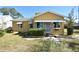 Yellow house with a green roof and a yard at 1360 Prescott S St, St Petersburg, FL 33712